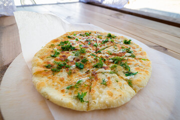 Close up pile of Caucasian khychin bread pie with stuffing