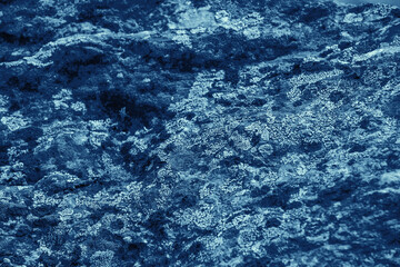 Vintage blue background. Rough painted wall of sapphire color. Imperfect plane of blue colored. Uneven old decorative toned backdrop of cyan tint. Texture of sapphirine hue. Ornamental stony surface.