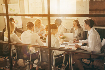 Back rear spine view photo of boss market leaders gathering training sit table tell say speak talk start-up unemployment crisis way-out plan in workplace workstation