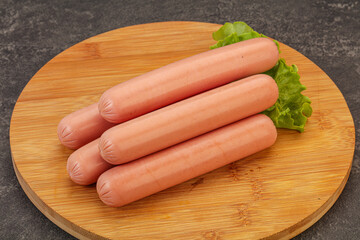 Tasty meat sausages over board