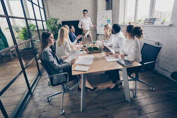 Profile side view of nice attractive stylish focused partners listening presenter workshop coaching sales growth at modern loft industrial brick interior style workplace workstation