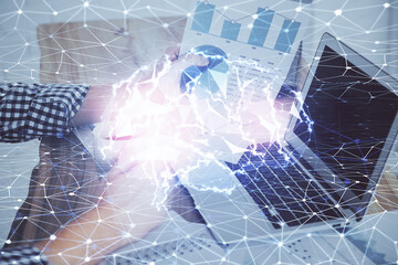 Businessman with computer background with brain theme hologram. Concept of brainstorm. Multi exposure.