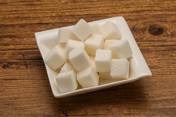 Refined white sugar cubs in the bowl