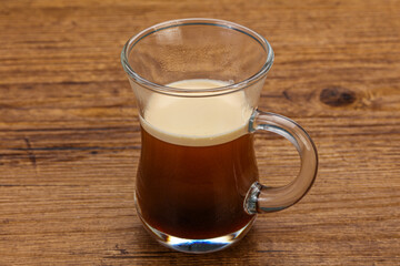 Hot Espresso coffee over wooden table