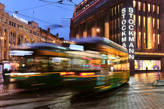 Helsinki, Finland - October 26, 2020: The trams are moving on Aleksanterinkatu street. The rainy autumn evening.