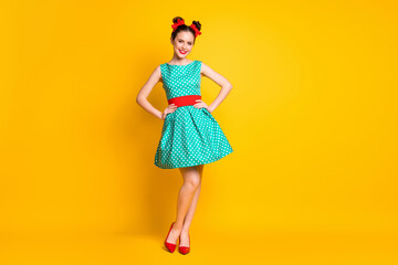 Full length body size view of nice cheery girl wearing teal dotted dress posing hands on hips...