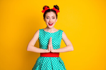 Portrait of nice pretty cheerful cheery girl wearing teal dress asking favor isolated over vibrant yellow color background