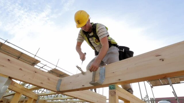 Carpenter constructing timber framed house