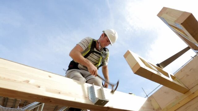 Carpenter constructing timber framed house