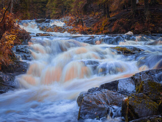 River with rapids in Karelia. Nature of Russia. Rocky section of Karelia river. Water vapor in middle of Karelia forest. Autumnal nature of outskirts of Priozersk. Landscape of northern Russia