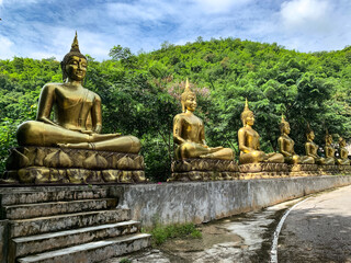 Row of golden Buddha Statue at Hua Khlum Monastic Residence, Suan phueng, Ratchaburi, Thailand.