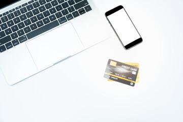 close up credit card laptop and amartphone on white background for online shopping