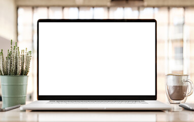 Frameless laptop with blank screen on desk in modern loft office interior – mockup template