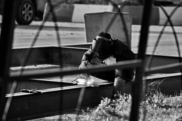 Welder at work on the road construction.