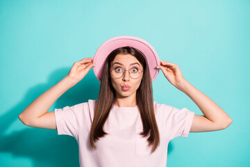 Photo portrait of cute surprised woman lady wear pink t-shirt arms vintage cap pouted lips isolated teal color background