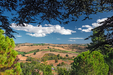 Fototapeta na wymiar Panoramic view of the gentle cultivated hills of the Marche Apennines in Italy