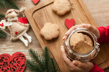 Christmas and New Year  2021 background with ingredients for cooking christmas baking decorated with fir tree. New Year's decor, homemade cookies and children's hands preparing for the holiday.