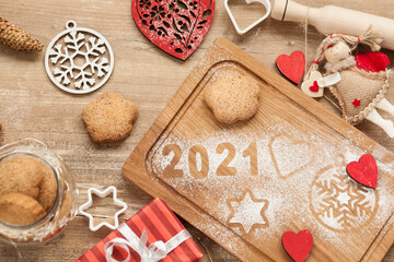 Christmas and New Year 2021 background with a festive plate with the inscription 2021 and boxes of gifts

