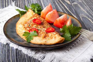Egg pancake with tomatoes and red pepper