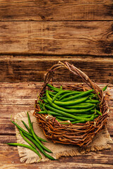 Phaseolus vulgaris, green common bean in wicker basket
