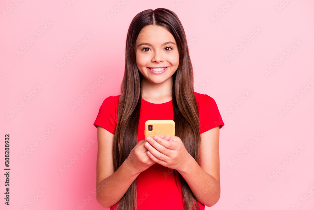 Sticker Photo of charming cute little lady long hairdo hands hold telephone chatting typing sending email surf internet shiny smile wear casual red t-shirt isolated pink color background