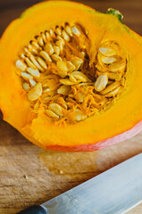 Half a ripe orange pumpkin on a cutting board. Ingredients for cooking. 
