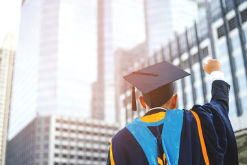 graduate, shot back side young male student in hand raising arms over fist thumb up during...