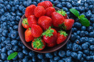 Blueberries and strawberries background.