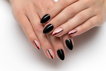 Black manicure with stripes on long sharp nails close-up on a white background. Autumn manicure.