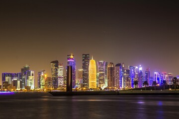 DOHA, QATAR - OCTOBER 27, 2017: Beautifully illuminated skyscrapers of Doha business city center at night. Qatar.