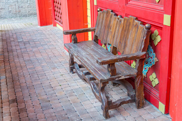 A recreation bench made of wood in a city park in autumn