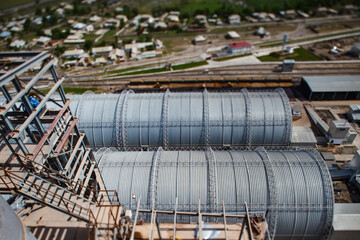 Standard Cement plant. Warehouse hangars view from top. Tilt-shift effect, partially blurred.