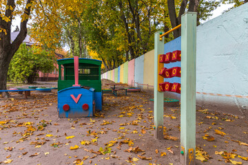 Children's colorful playground in the park in autumn.