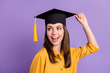 Close-up portrait of her she attractive cheerful glad smart girl sientist wearing touching graduate cap having fun isolated on bright vivid shine vibrant lilac violet color background