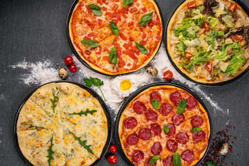 Four types of pizza shot from above on wooden boards