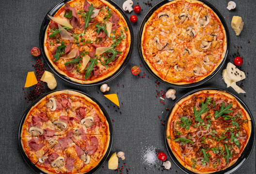 Four Types Of Pizza Shot From Above On Wooden Boards