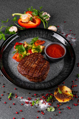 Beef steak with spices, grilled vegetables, asparagus and cream sauce. Gourmet dish