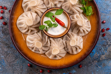 National Georgian cuisine. Khinkali with meat. Khinkali on a wooden board close-up.