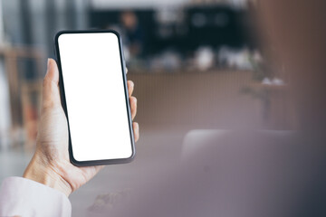 cell phone blank white screen mockup.woman hand holding texting using mobile on desk at coffee shop.background empty space for advertise.work people contact marketing business,technology