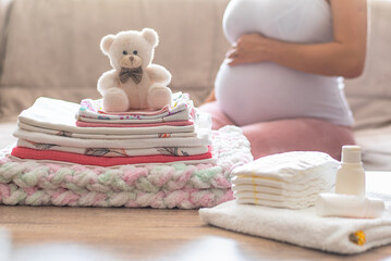 Pregnant woman is getting ready for the maternity hospital, packing baby stuff. pregnant woman...