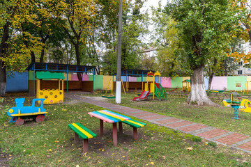 Children's colorful playground in the park in autumn.