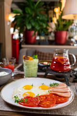 Helpful appetizing breakfast on a white plate. Scrambled eggs with vegetables and croutons in a cafe. Breakfast in the cafe: scrambled eggs, sausages and toast