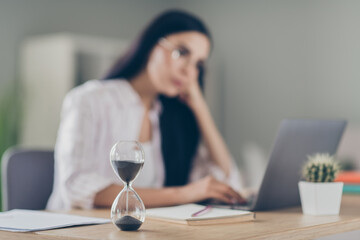 Close up photo of bored woman broker looking waiting browsing internet indoor workstation