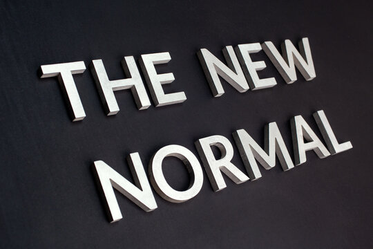 words the new normal on black surface in tilted linear perspective - Powered by Adobe