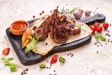 A rack of delicious baby back ribs with barbecue sauce, french fries, coleslaw and beer.