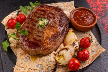 Grilled beefsteak, baked potatoes and vegetables