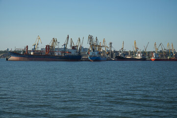 View from afar on cranes and ships in the port of Berdyansk.