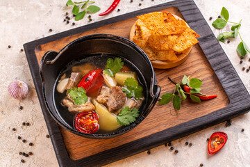 Braised pork ribs Chinese traditional food Serve with blanched kale in a ceramic pot. And sour sauce