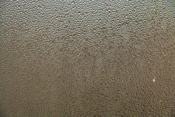 background of water drops or dew on glass in the form of a pattern