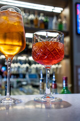 Italian Aperol Spritz cocktail with orange slices on a bar counter. Summer sangria or red cocktail with ingredients